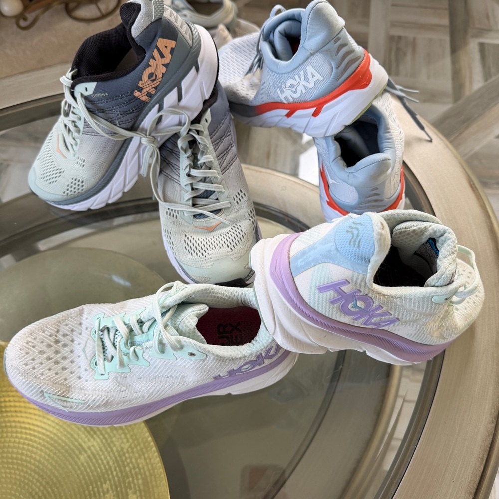 Three pairs of HOKA running shoes and 
One pair of Brooks Ghost size 8